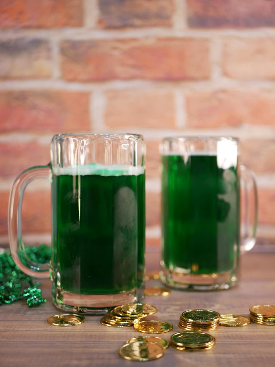Clear Glass Beer Mug with Green Liquid on Brown Wooden Surface