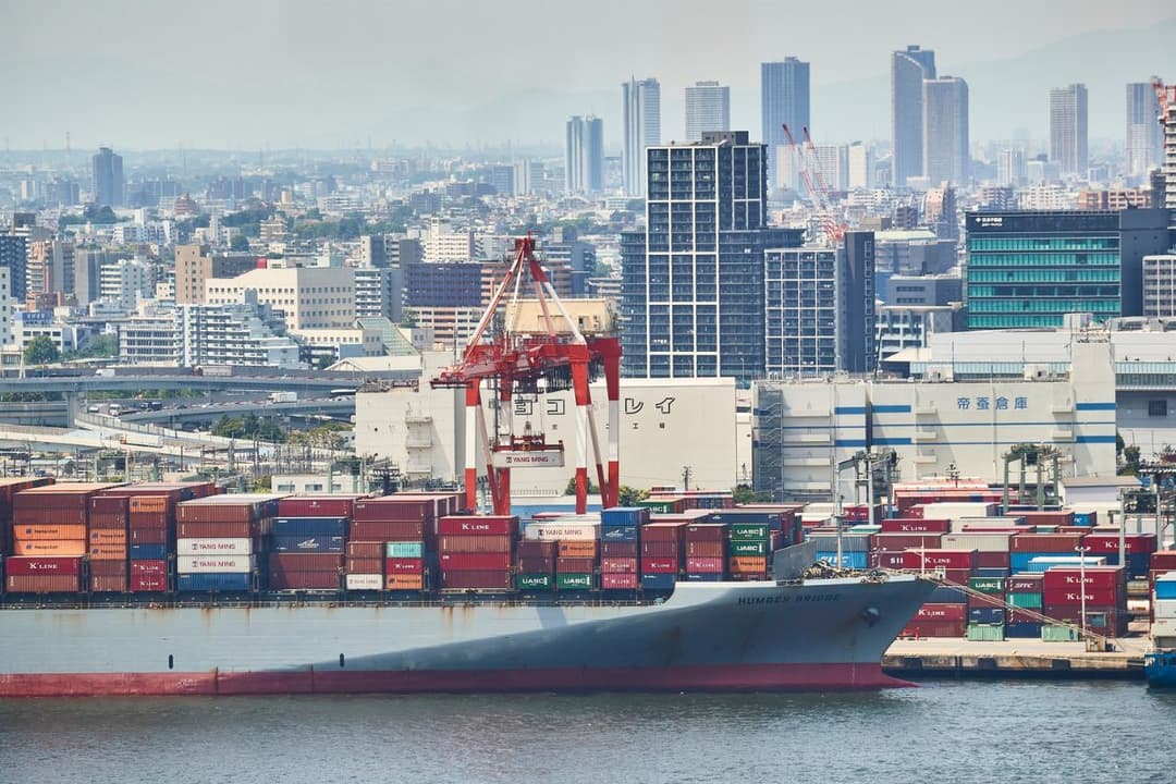 Container Ship at Port with City Skyline