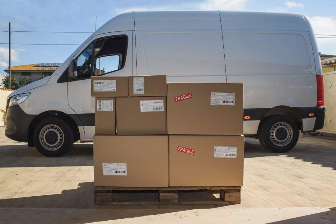 Courier Service Parcels by a Delivery Van Outdoors